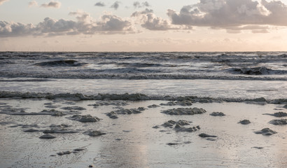 sea foam washed up or blown onto a northsea beach