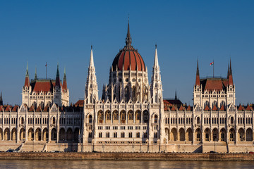 Fototapeta na wymiar Hungary, Budapest: Famous Hungarian Parliament Building at sunny afternoon in the city center of the Hungarian capital with Donau Danube water, blue sky in background - travel architecture politics