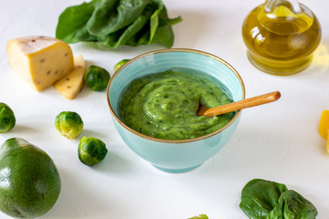 Cream soup with avocado, spinach and cheese. Healthy eating. White background