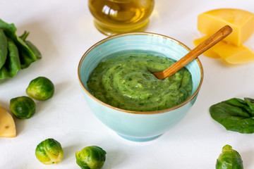 Cream soup with avocado, spinach and cheese. Healthy eating. White background