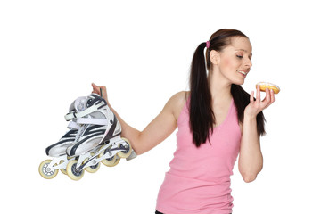 Young  sporty woman with rollerskates and donut.