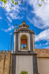 View of a catholic church tower on medieval village inside the fortress and Luso Roman castle of Óbidos