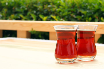 Two glasses of Turkish tea in traditional cup on wooden table.Copy space,afternoon teatime.
