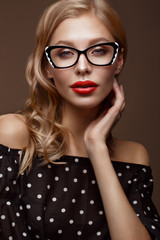 Beautiful girl in stylish clothes with glasses for vision and red sexy lips.