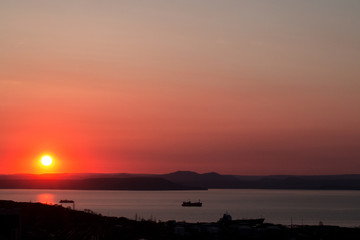 Red, beautiful colorful sunset, sunrise on the sea. Dramatic story with ships on the sea sun.