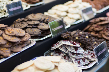 Selling sweets at a street fair in Budapest. Chocolate cookies of different tastes on the counter.
