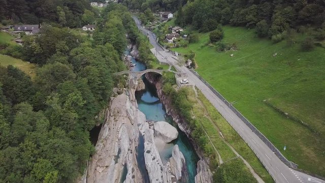 Aerial dolly down on the river towards the bridge "Ponte dei Salti" in Lavertezzo. Fantastic natural environment without pollution.