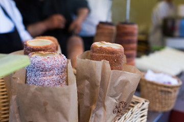 Trdelnik or Trdlo or Kurtosh Kalach being baked in a street bakery in Budapest