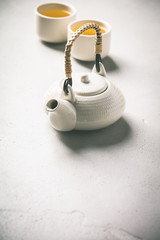 Ctramic teapot and cups on concrete background