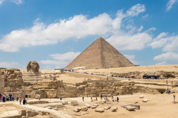 Fototapeta na wymiar Giza, Egypt - April 19, 2019: The pyramid of Khufu and the Great Sphinx of Giza, Egypt