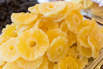 Dried pineapples are on the counter close-up.