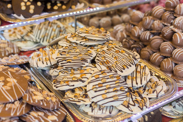 Selling sweets at a street fair in Budapest. Chocolate cookies of different tastes on the counter.