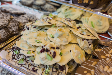 Selling sweets at a street fair in Budapest. Chocolate cookies of different tastes on the counter.
