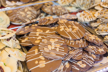 Selling sweets at a street fair in Budapest. Chocolate cookies of different tastes on the counter.