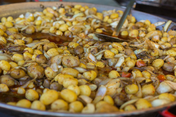 Young fried, whole village potatoes with onions in a large pan. Vending. Food Festival in Hungary