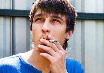 Fototapeta na wymiar Young Man with a Cigarette