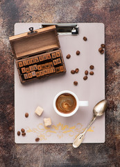 Clipboard, set with letters and cup coffee. Top view. Flat lay style.