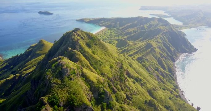 Aerial, drone shot, panning around a Indonesian mountain, on Padar island, on a sunny evening, in Indonesia