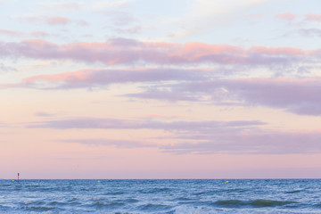 Naklejka na ściany i meble Pastel color sunset sky over the sea .
