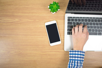 Men wore blue striped shirts, printed on a laptop keyboard on a wooden table. Top view with copy space.