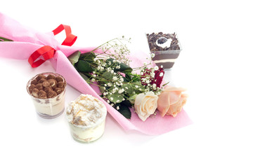 A bouquet of roses and cake on a white background