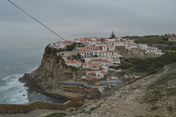 Views Of The Houses Perfectly Located On A Cliff And With A Natural Pool On Their Background In Colares. Nature, architecture, history. April 14, 2014. Colares, Sintra, Lisbon, Portugal.