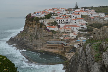 Views Of The Houses Perfectly Located On A Cliff And With A Natural Pool On Their Background In Colares. Nature, architecture, history. April 14, 2014. Colares, Sintra, Lisbon, Portugal.