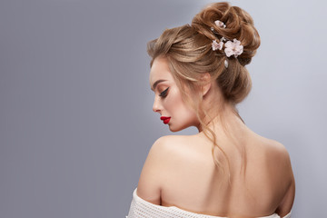 woman's back with opened shoulders and perfect flowered hairstyle