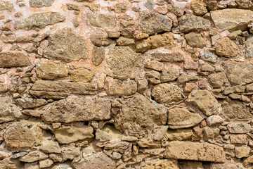 The background old brown stony wall