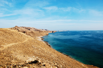 A coastline in Oman with deep blue water