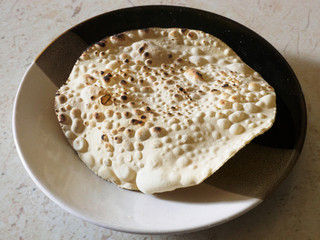 Indian bread on a saucer, Kochi, Kerala, India