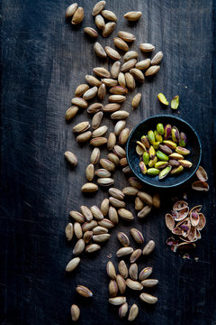 Pistachios over black wooden background