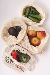 Fresh organic fruits and vegetables in cotton eco bags