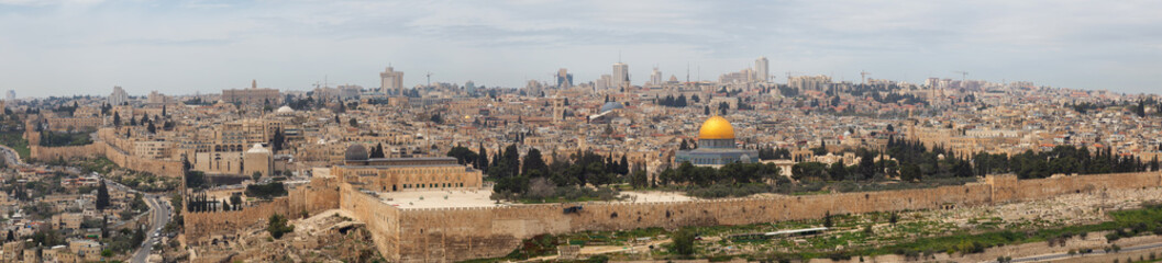 Fototapeta premium Beautiful panoramic aerial view of the Old City, Tomb of the Prophets and Dome of the Rock during a sunny and cloudy day. Taken in Jerusalem, Capital of Israel.