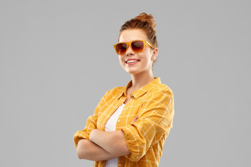 summer, eyewear and people concept - smiling red haired teenage girl in sunglasses and yellow...