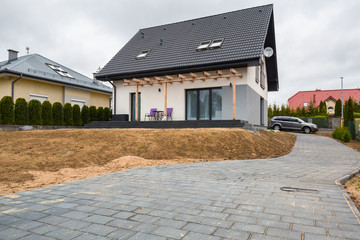 House with new laid concrete paver blocks