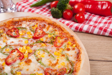 Close up of delicious italian pizza with vegetables & cheese.