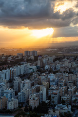 Aerial view of a residential neighborhood in a city during a cloudy sunrise. Taken in Netanya, Center District, Israel.