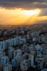 Aerial view of a residential neighborhood in a city during a cloudy sunrise. Taken in Netanya, Center District, Israel.