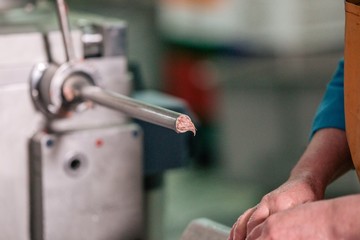 Workers in the food industry make meat sausages with the help of equipment
