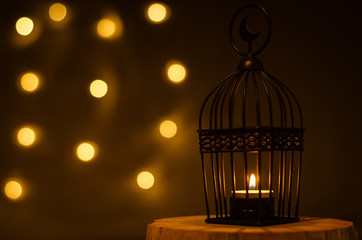 Beautiful Lantern that have moon symbol on top with bokeh light on dark background for the Muslim...