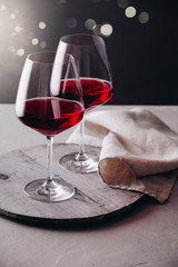 Glasses of red wine on concrete background, close up
