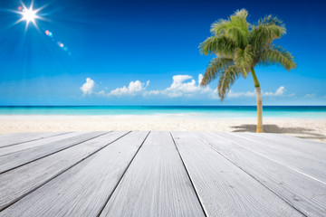 Desk of free space and summer background of ocean and beach with palm. Sunny day and blue sky. 