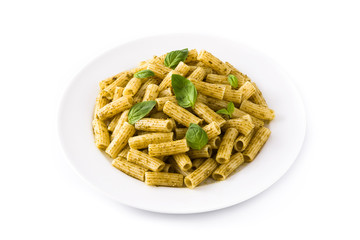 Penne pasta with pesto sauce and basil on a plate, isolated on white background