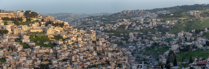 Fototapeta na wymiar Aerial panoramic cityscape view of residential neighborhood during a sunny sunset. Taken in Jerusalem, Israel.