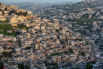 Fototapeta na wymiar Aerial cityscape view of residential neighborhood during a sunny sunset. Taken in Jerusalem, Israel.
