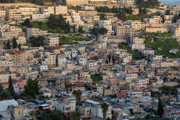 Aerial cityscape view of residential neighborhood during a sunny sunset. Taken in Jerusalem, Israel.