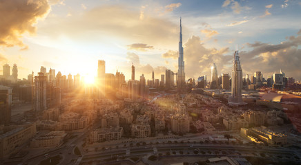 Skyline of Dubai Downtown at sunset with a dramatic sky
