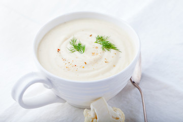 Cauliflower soup on a white background. Healthy food. Close up.
