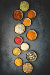 Obraz na płótnie Canvas Various bowls of spices over dark background